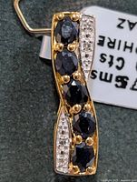 Front view of pendant showing sapphires and topaz accents