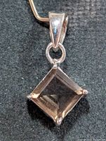 Front view showing square smoky quartz and silver prongs