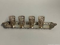 Tray with four silver overlay shot glasses displayed