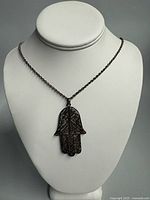 Necklace on bust showing full view of chain and pendant