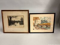 Both framed etchings side by side