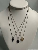 All three necklaces displayed on bust showing chain lengths and pendant styles