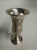 Front view of sterling silver kiddush cup showing engraving and pedestal base