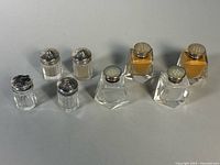 Eight shakers shown; focus on four square crystal shakers with sterling lids