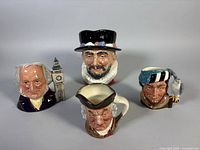 Group shot of four Royal Doulton character mugs
