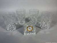 Group shot of four crystal glasses and crystal mantle clock