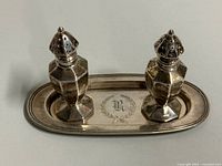 Tray with both shakers in place showing monogram and general tarnish