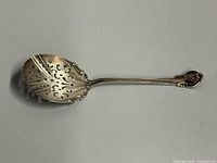 Full view of sterling reticulated berry spoon front