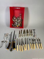 Overview of entire lot with red bin and laid-out utensils