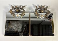 Front view of both mirrors showing metal acanthus crests and braid trim