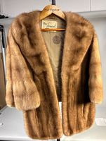 Full front view of mink stole on hanger