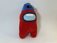Front view of red crewmate plush showing visor and blue hat