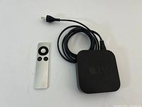 Apple TV box, remote and cable overall