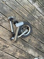 overall view of folded aluminum fork, arms and wheel