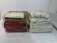 Two stacks of ten packaged curtain and sheer panels
