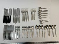 All cutlery laid out to show knife, fork and spoon quantities