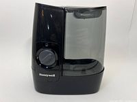 Front view of black Honeywell humidifier showing control dial and water tank