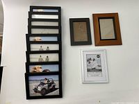 Eight stacked black 4x6 frames plus three assorted 5x7 frames in black, brown and white