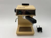 Front view of beige Gaggia Fantastico espresso machine with portafilter attached and separate black double pour adaptor