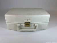 Closed carrying case front view showing brand and latch