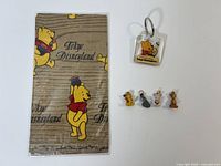 Bandana in sleeve, keychain, four charms overview