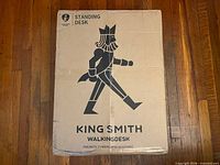 Front of sealed shipping box showing King Smith branding and walking figure logo