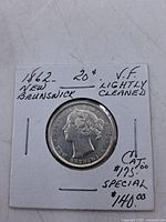Obverse side of 1862 New Brunswick 20 cents coin in holder