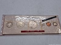 Full view of sealed six-coin set in original card and sleeve