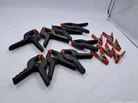 Group of six plastic and eight metal spring clamps