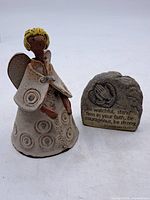 angel figurine and scripture plaque side by side