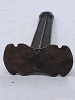 Full view of cast iron cobbler's shoe stand showing base.