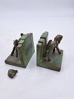 Pair of metal horse bookends with detached head piece shown