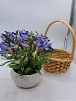 Full view of ceramic-planter floral arrangement and wicker basket
