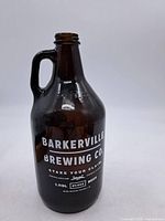Front view showing Barkerville Brewing Co. logo and handle
