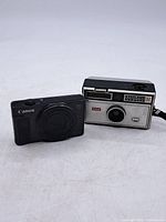 Front view of Canon PowerShot SX620 HS and Kodak Instamatic 104