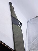 Full view of green vinyl rifle case with handles and zipper