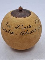Full view of gourd jar showing inscription and lid