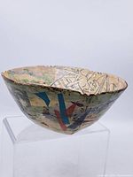 Side view of bowl showing exterior geometric decoration and interior figurative crackle glaze