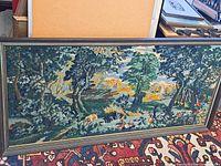 Front view of framed needlepoint landscape