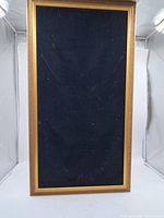 Full view of framed navy velvet jewelry display board