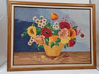 Front view of framed floral needlepoint artwork