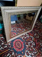 Full view of rectangular gilded framed mirror