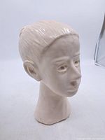 Front three-quarter view of ceramic female head bust