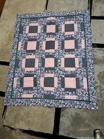 Full view of quilt front showing overall pattern, borders and size reference
