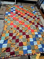 Full view of quilt laid out flat showing overall patchwork design and dimensions