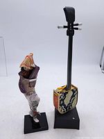 Full view of geisha figurine and shamisen music box on stands