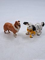 Both porcelain dog figurines side by side