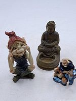Overview of all three figurines: Buddha, gnome, fisherman