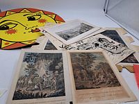 Overview of stacked antique prints showing two coloured Caribbean engravings on top plus additional monochrome sheets beneath