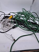 Pile of green, black and white extension cords